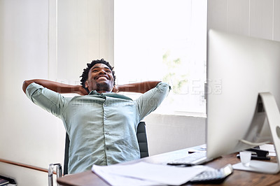 Buy stock photo Cropped shot of a young designer taking a break at his office desk
