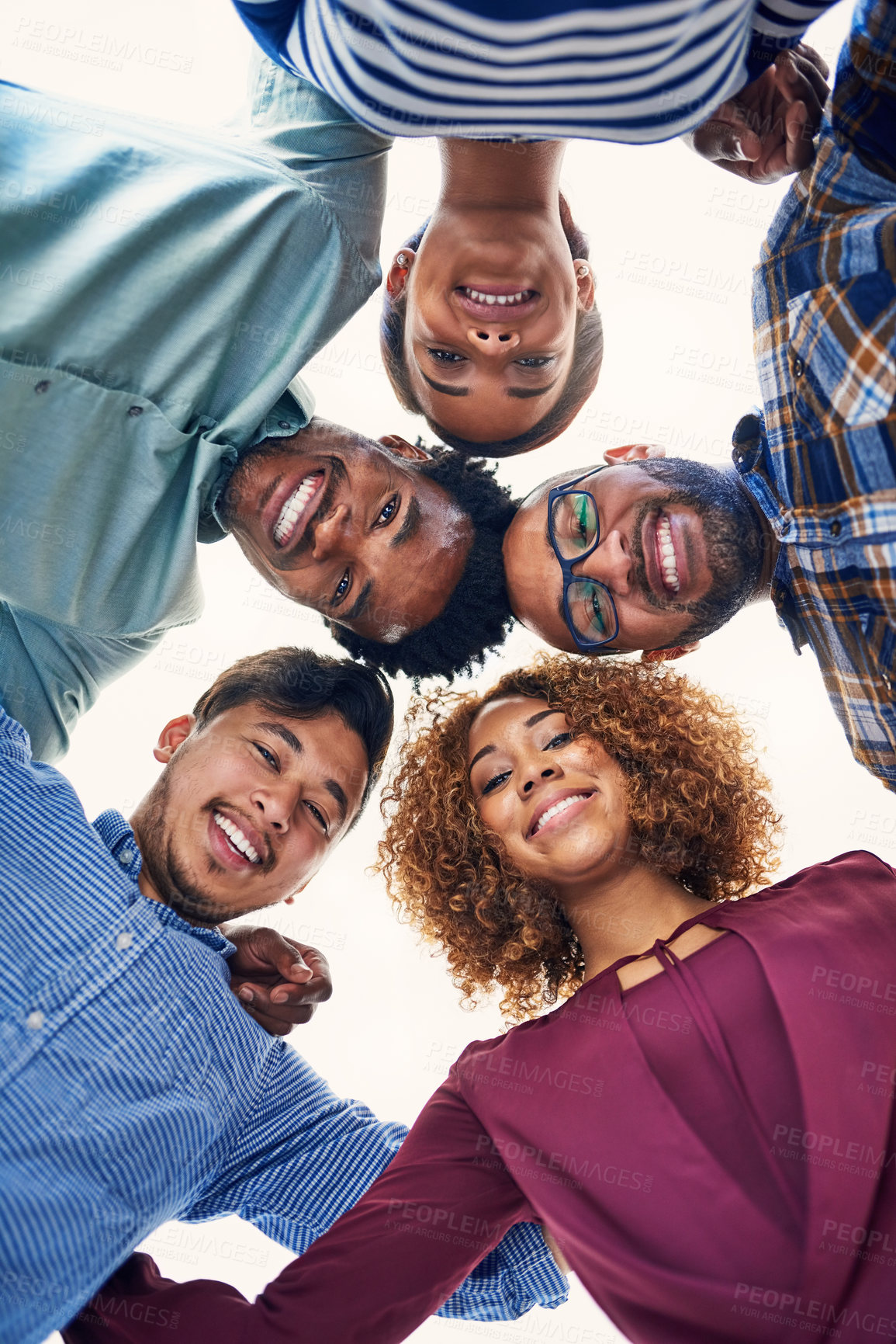 Buy stock photo Portrait of a team of designers putting their heads together in a huddle