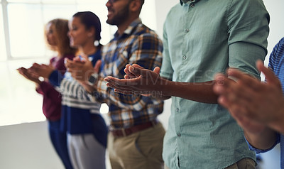 Buy stock photo Cropped shot of a team of designers applauding together in an office