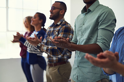 Buy stock photo Cropped shot of a team of designers applauding together in an office