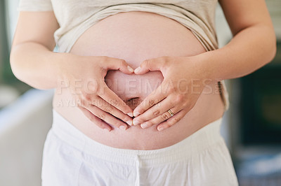 Buy stock photo Hands, woman and pregnant stomach with heart for love or excitement for parenthood, motherhood and waiting for baby arrival. Mother to be, home and holding belly to feel kick on maternity leave.