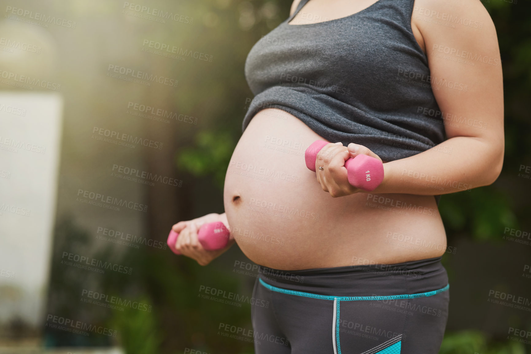 Buy stock photo Cropped shot of an unrecognizable pregnant woman exercising outside