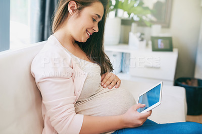 Buy stock photo Cropped shot of an attractive young pregnant woman working from home