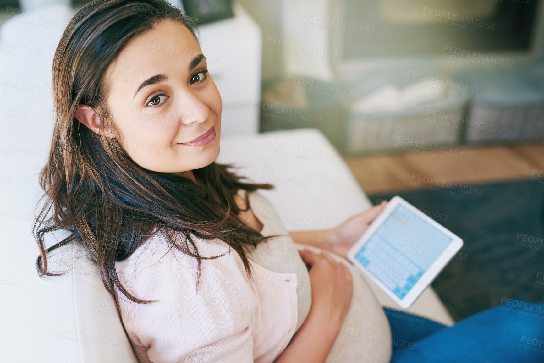 Buy stock photo Cropped portrait of an attractive young pregnant woman working from home