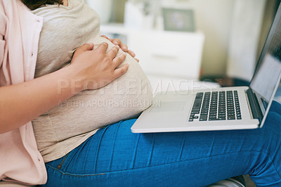 Buy stock photo Hands, stomach and pregnant woman with laptop on sofa for maternity leave, working from home or remote work. Pregnancy, couch and person on computer for parenting website, research or online shopping