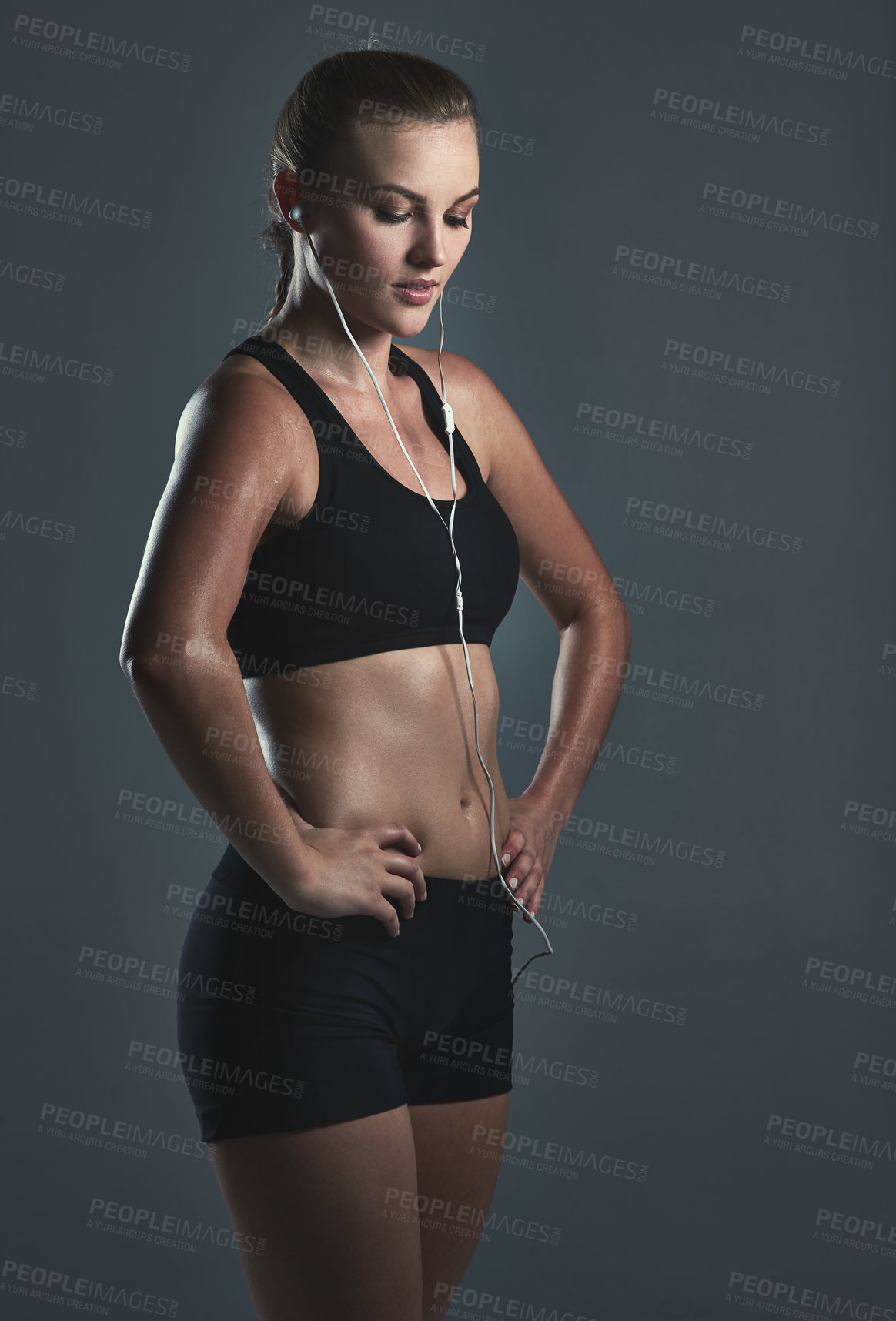 Buy stock photo Fitness, thinking and woman with earphones in studio for streaming music, listening to podcast or radio on gray background. Thoughtful, sport and athlete for training ideas, workout or audio playlist