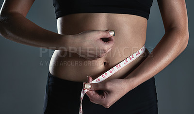 Buy stock photo Weightloss, stomach and hands of person, measuring tape and diet for body, fitness and workout in studio. Black background, model and sportswear for results, training and healthy with exercise