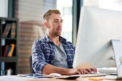 Buy stock photo Cropped shot of a young designer working on a computer in an office