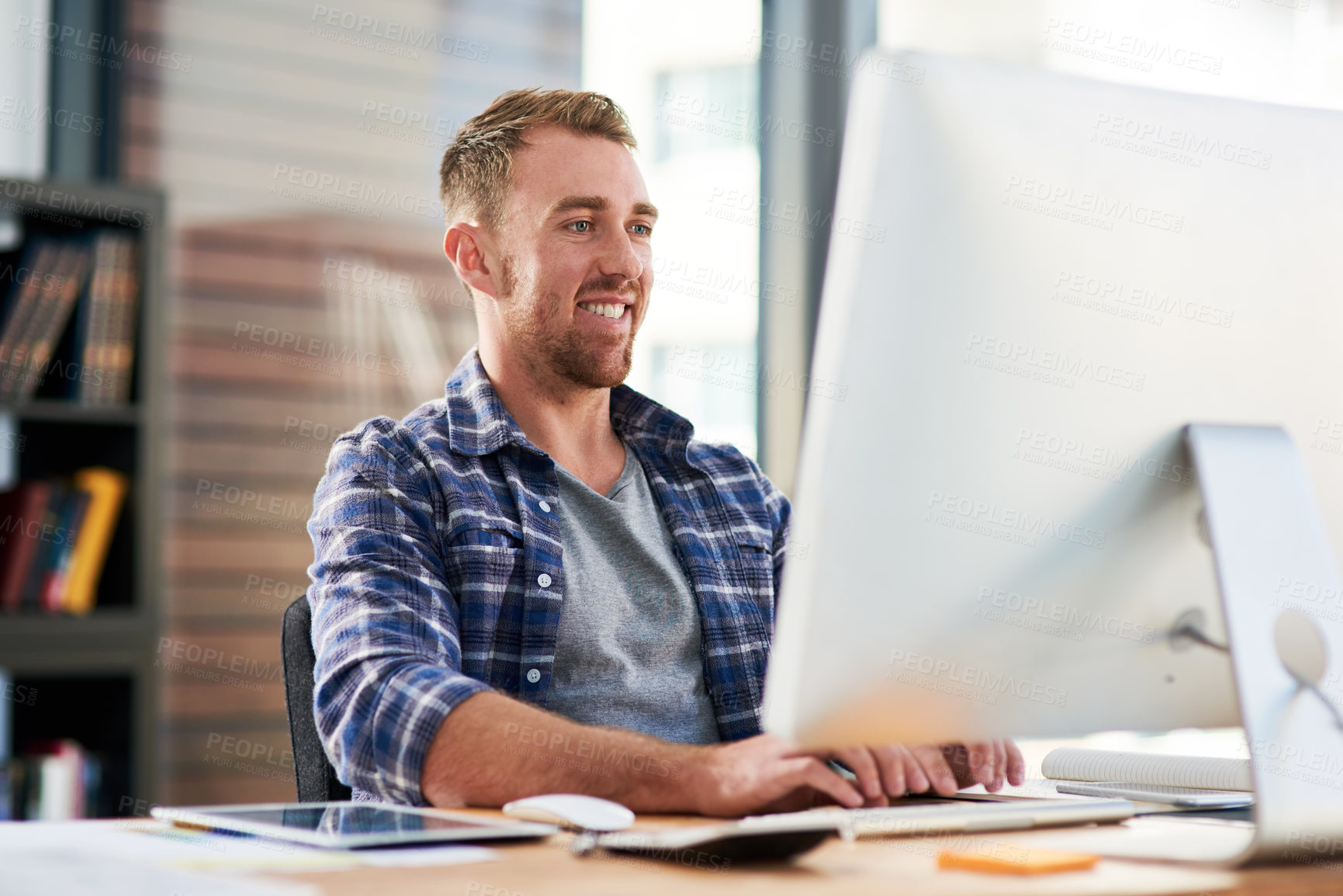 Buy stock photo Cropped shot of a young designer working on a computer in an office