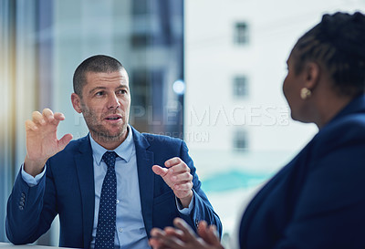 Buy stock photo Cropped shot of two businesspeople meeting in the boardroom