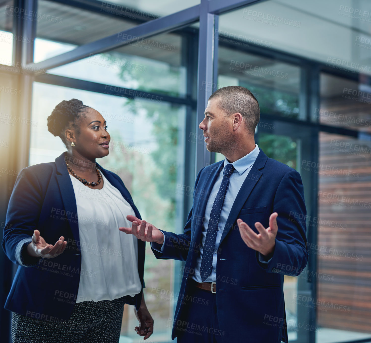 Buy stock photo Cropped shot of two businesspeople talking in the office