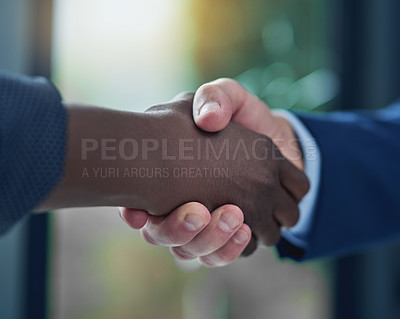 Buy stock photo Cropped shot of two businesspeople shaking hands in the boardroom