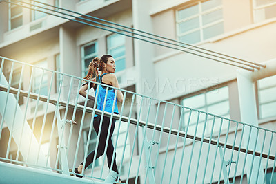 Buy stock photo Shot of young woman working out in the city