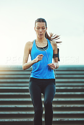 Buy stock photo Shot of young woman working out in the city