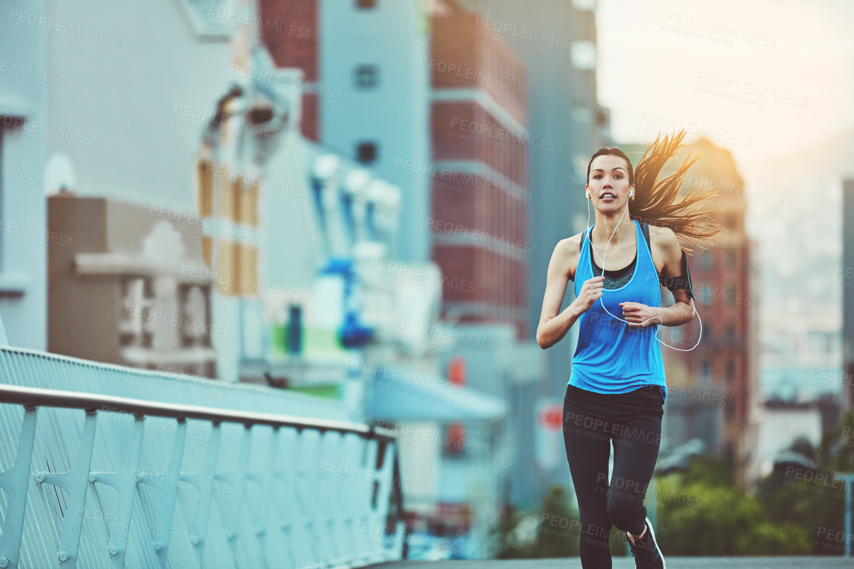Buy stock photo Woman, street and running for fitness with earphones, music streaming app and phone in morning. Girl, person or runner with audio, radio and listen on subscription in workout on road in San Francisco