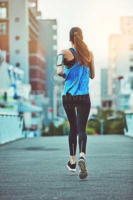 Buy stock photo Shot of a young woman out in the city for her morning run