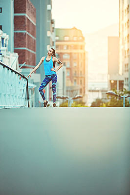 Buy stock photo Shot of a young woman looking exhausted during her morning run