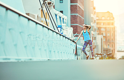 Buy stock photo Shot of a young woman looking exhausted during her morning run