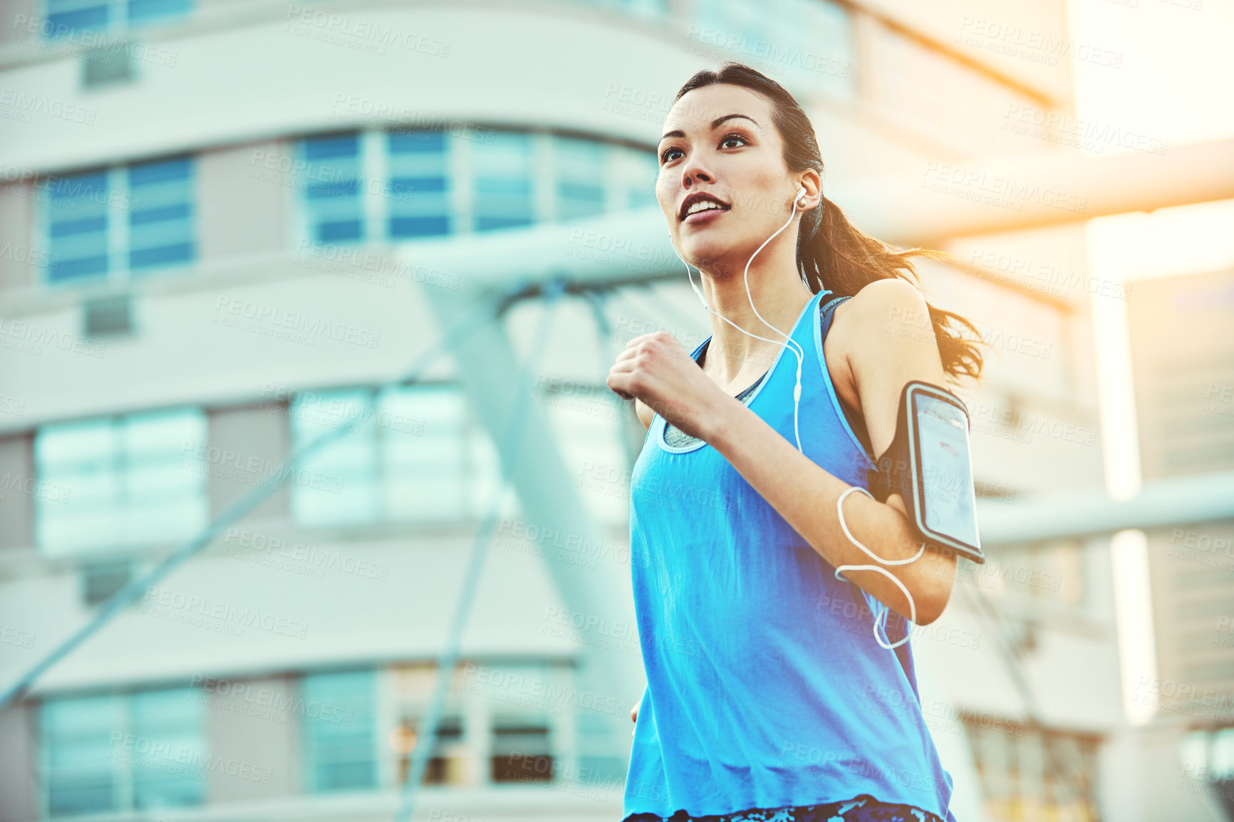 Buy stock photo Shot of a young woman out in the city for her morning run