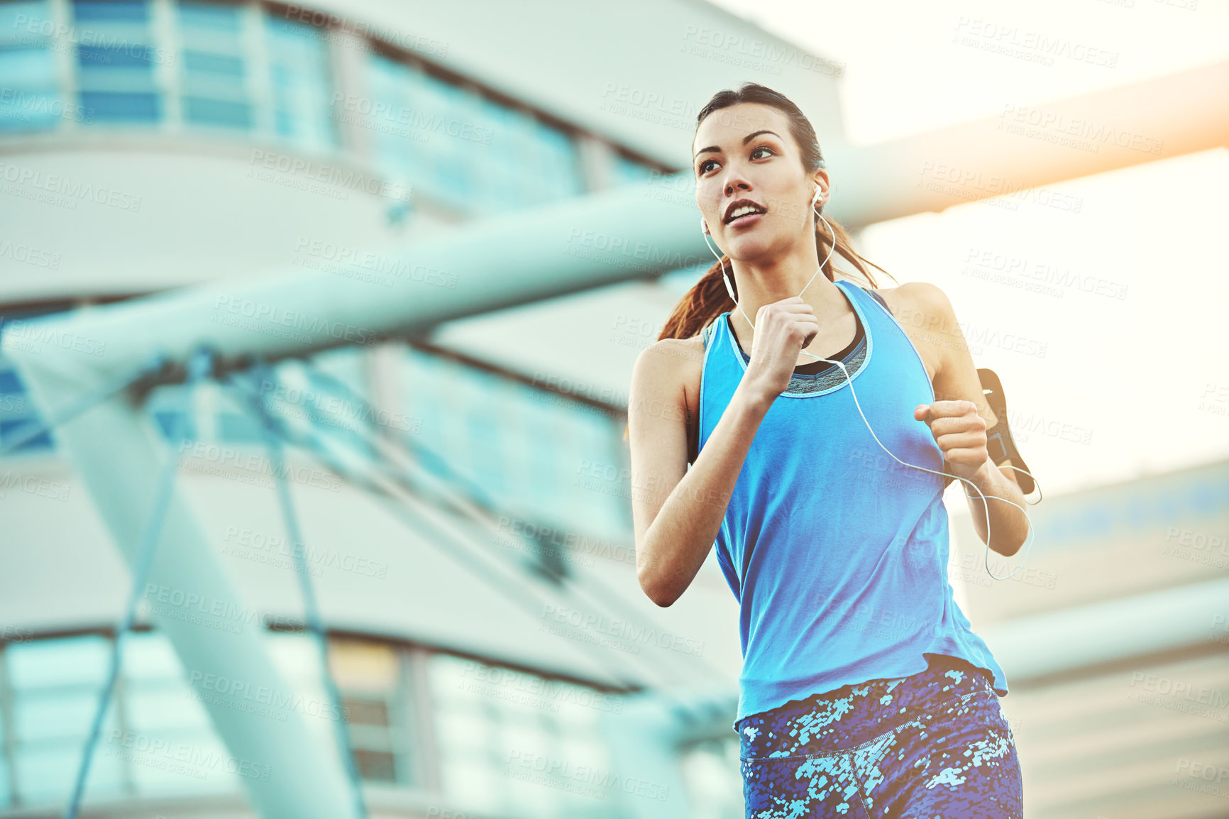 Buy stock photo Shot of a young woman out in the city for her morning run