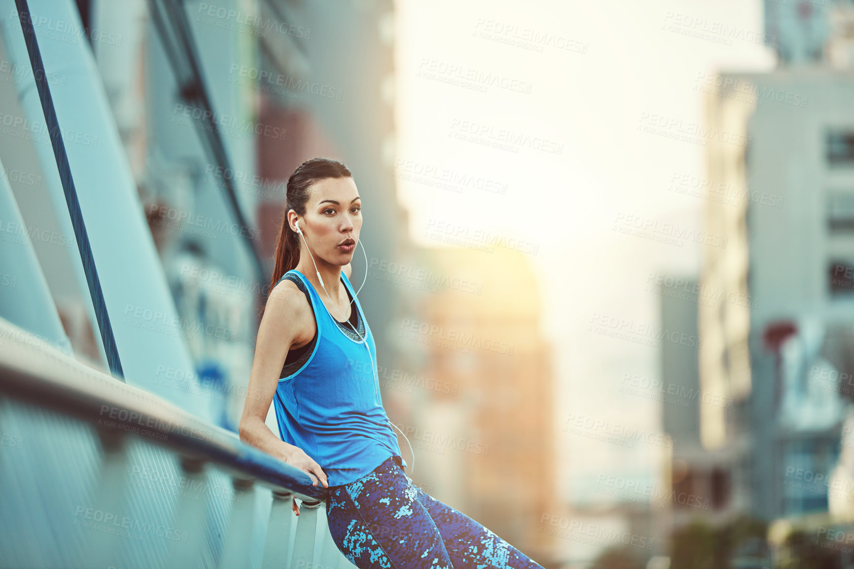 Buy stock photo Shot of a young woman looking exhausted during her morning run