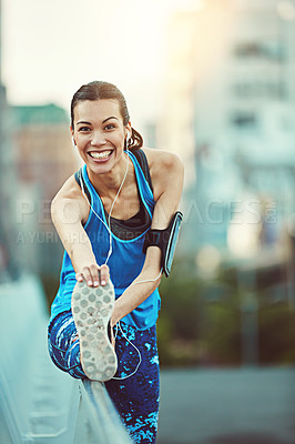 Buy stock photo Shot of sporty young woman stretching before her run