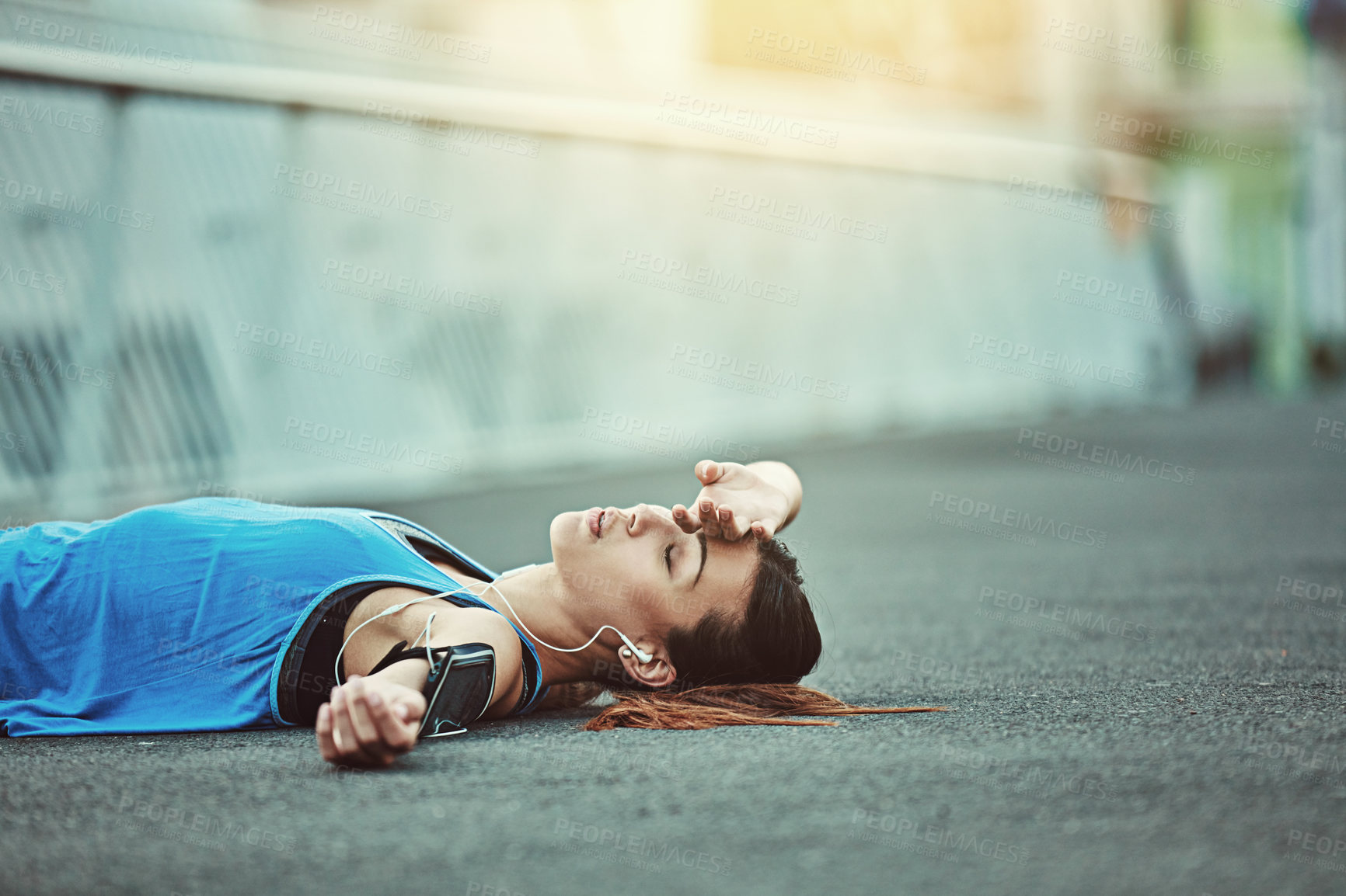 Buy stock photo Shot of a young woman looking exhausted during her morning run