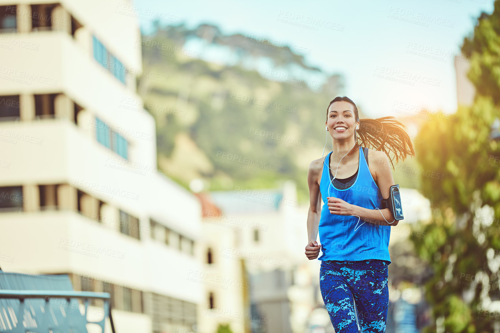 Buy stock photo Shot of a young woman out in the city for her morning run