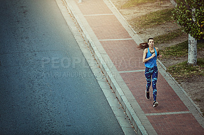 Buy stock photo Shot of a young woman out in the city for her morning run