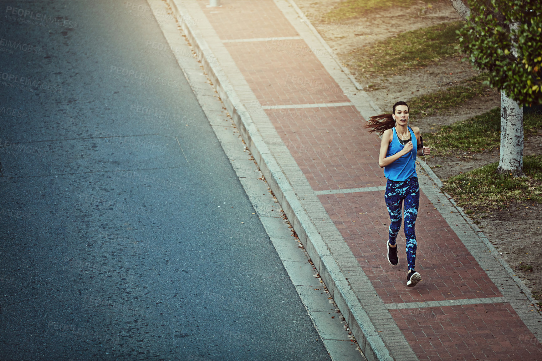 Buy stock photo Shot of a young woman out in the city for her morning run