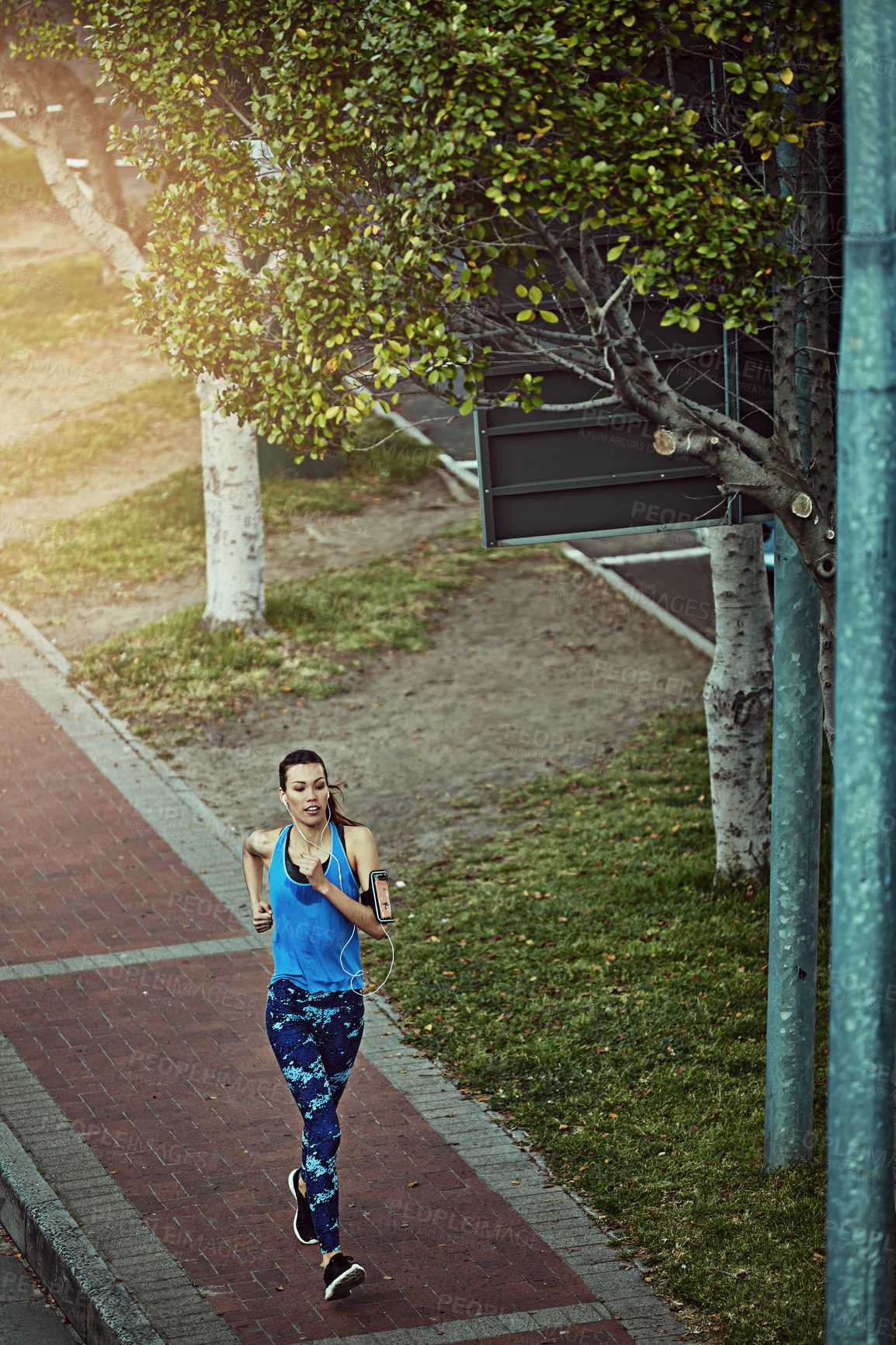 Buy stock photo Above, running and woman in city for exercise, training and fitness for wellness. Outdoor, female person and runner for workout, muscle development and endurance with health challenge in New York