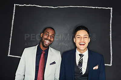 Buy stock photo Portrait of two young businessmen standing against a chalk illustration of a box on a dark background