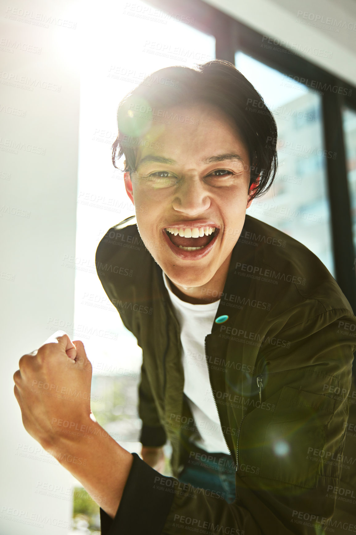 Buy stock photo Portrait of a happy young businessman celebrating a victory alone in the office