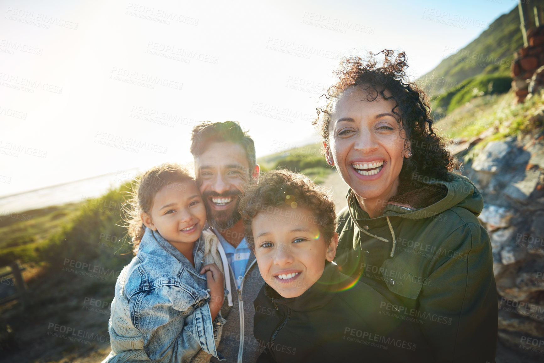 Buy stock photo Holiday, mountain and outdoor portrait of family with smile, nature and bonding together on travel adventure. Mom, dad and children on summer vacation with hiking, happy face and sunshine on hill