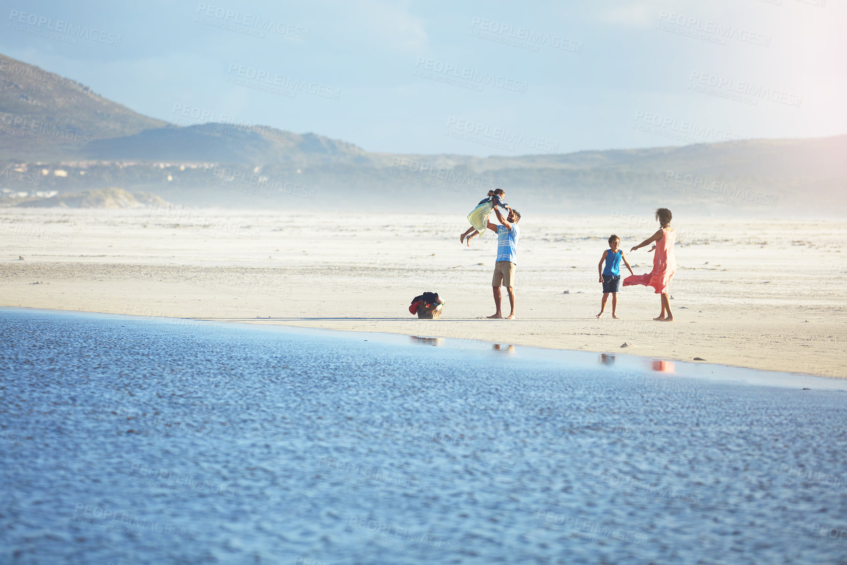 Buy stock photo Shot of a family of four enjoying a day at the beach