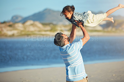 Buy stock photo Shot of a father spending the day at the beach with his daughter