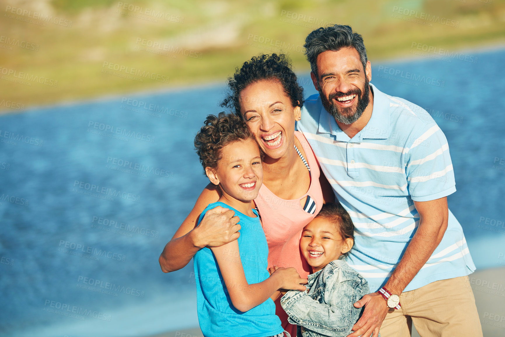 Buy stock photo Holiday, ocean and outdoor portrait of family with smile, nature and bonding together on travel adventure. Mom, dad and children on summer vacation with sea water, happy face and sunshine at beach