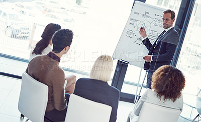 Buy stock photo Cropped shot of a businessman giving a presentation to his colleagues in an office