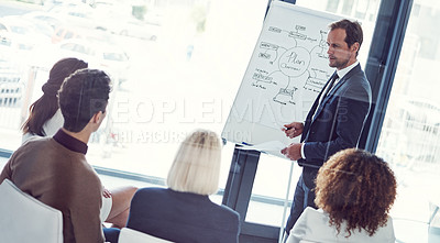 Buy stock photo Cropped shot of a businessman giving a presentation to his colleagues in an office