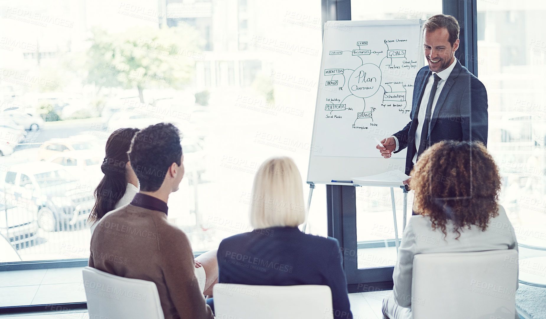 Buy stock photo Cropped shot of a businessman giving a presentation to his colleagues in an office