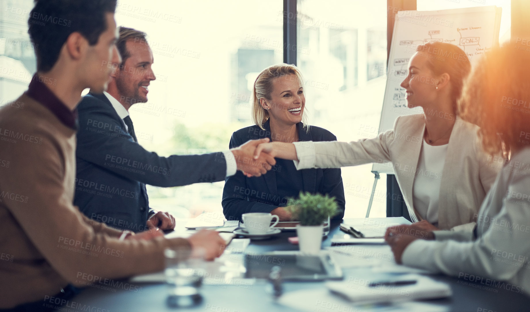 Buy stock photo Cropped shot of businesspeople shaking hands during a meeting in an office