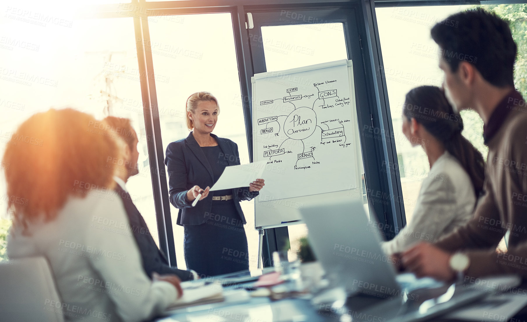 Buy stock photo Cropped shot of a businesswoman giving a presentation to her colleagues in the boardroom