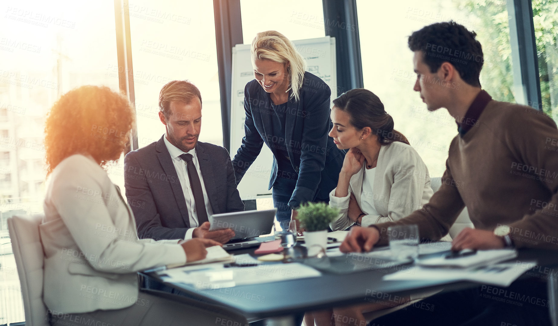 Buy stock photo Cropped shot of businesspeople working together on a digital tablet in an office