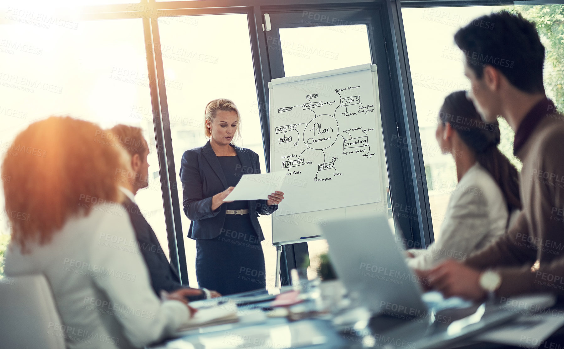 Buy stock photo Cropped shot of a businesswoman giving a presentation to her colleagues in the boardroom