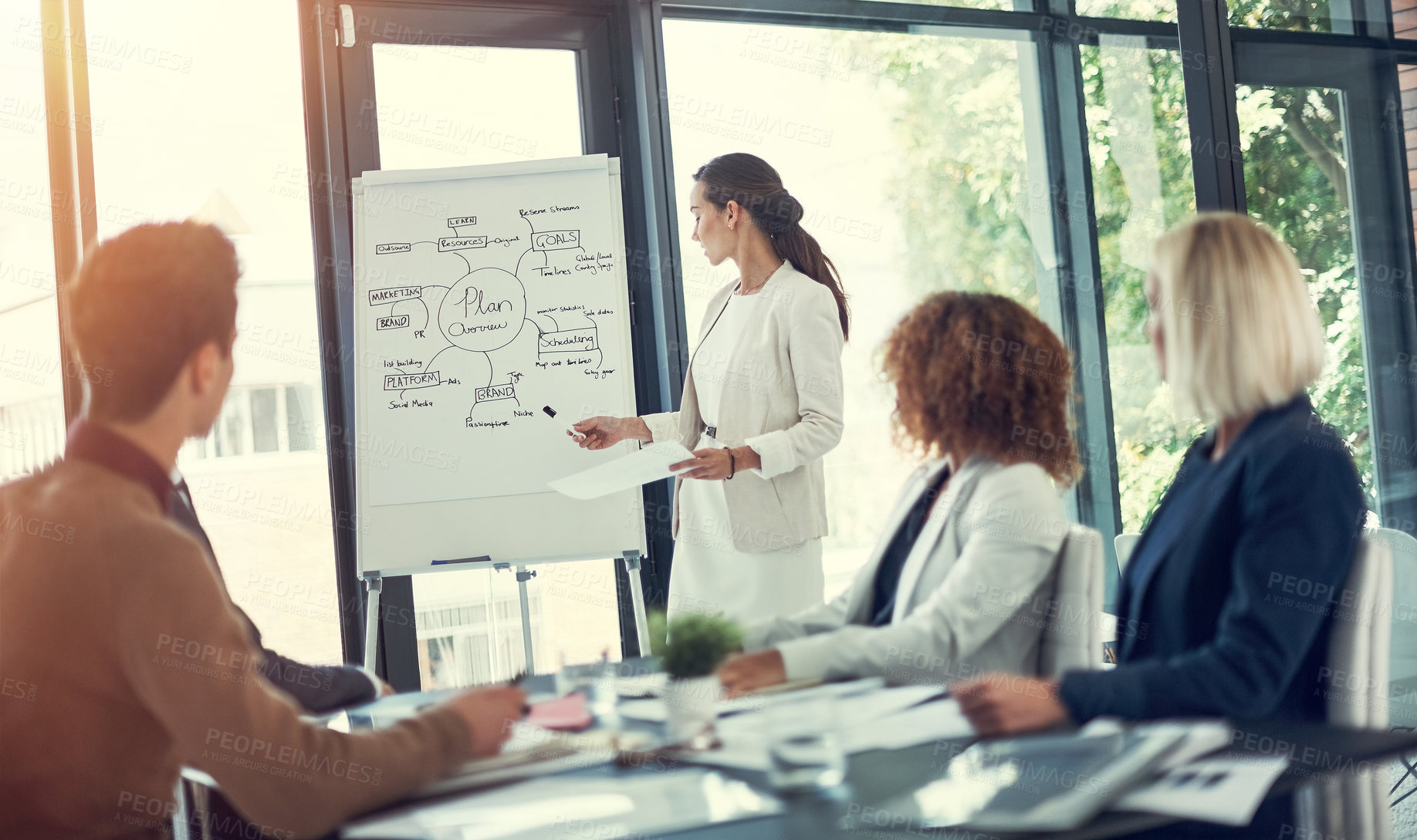 Buy stock photo Cropped shot of a businesswoman giving a presentation to her colleagues in the boardroom