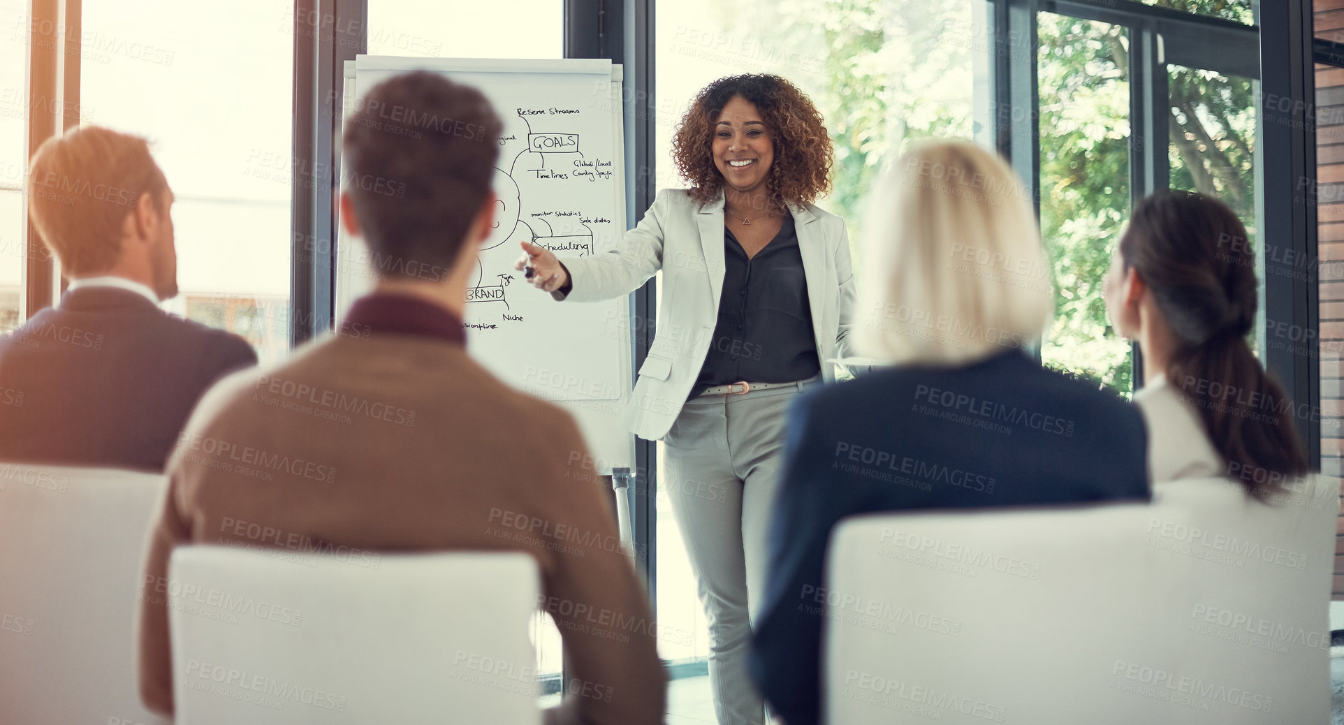 Buy stock photo Cropped shot of a businesswoman giving a presentation to her colleagues in the boardroom