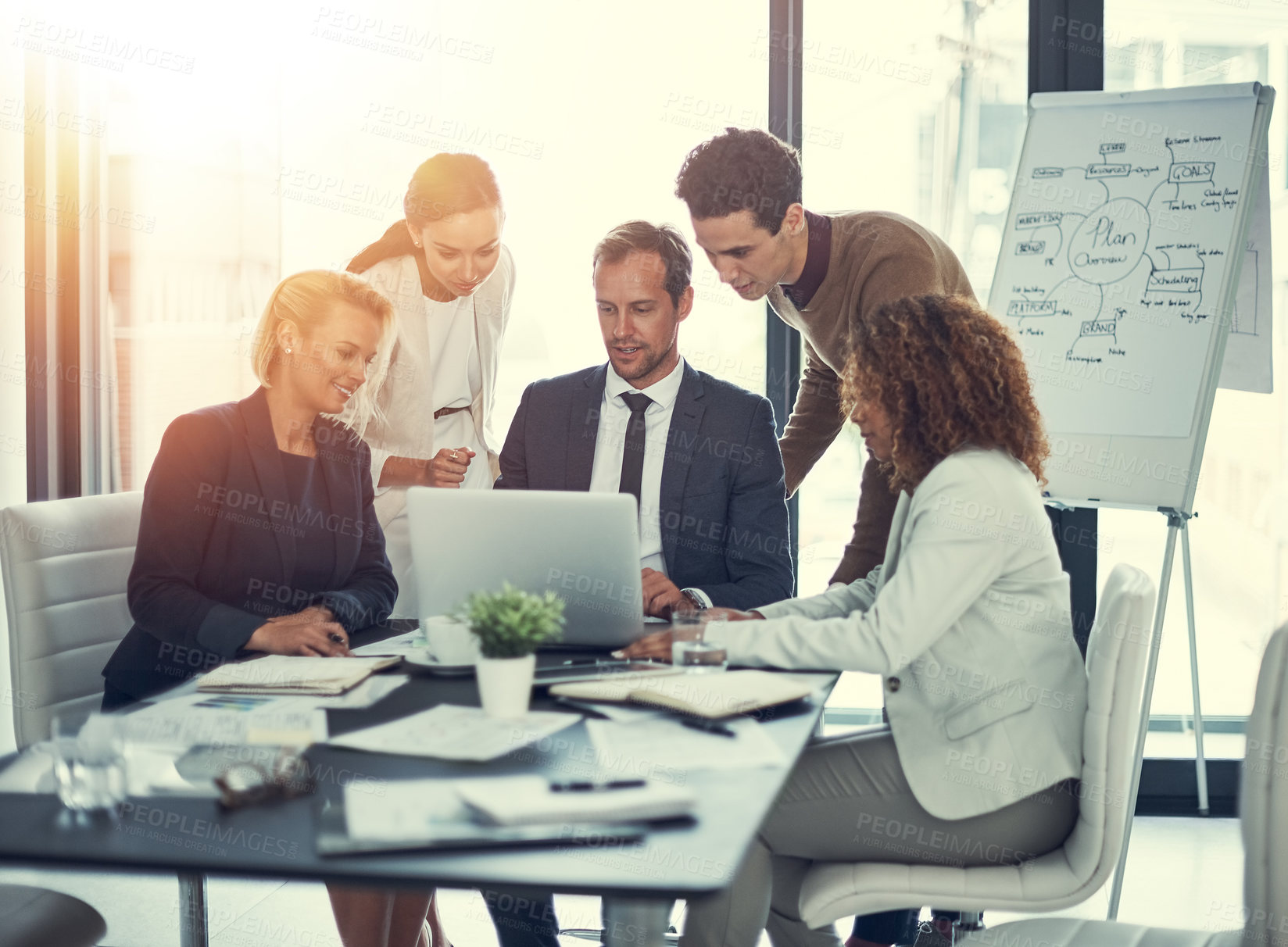 Buy stock photo Cropped shot of businesspeople working together on a laptop in an office