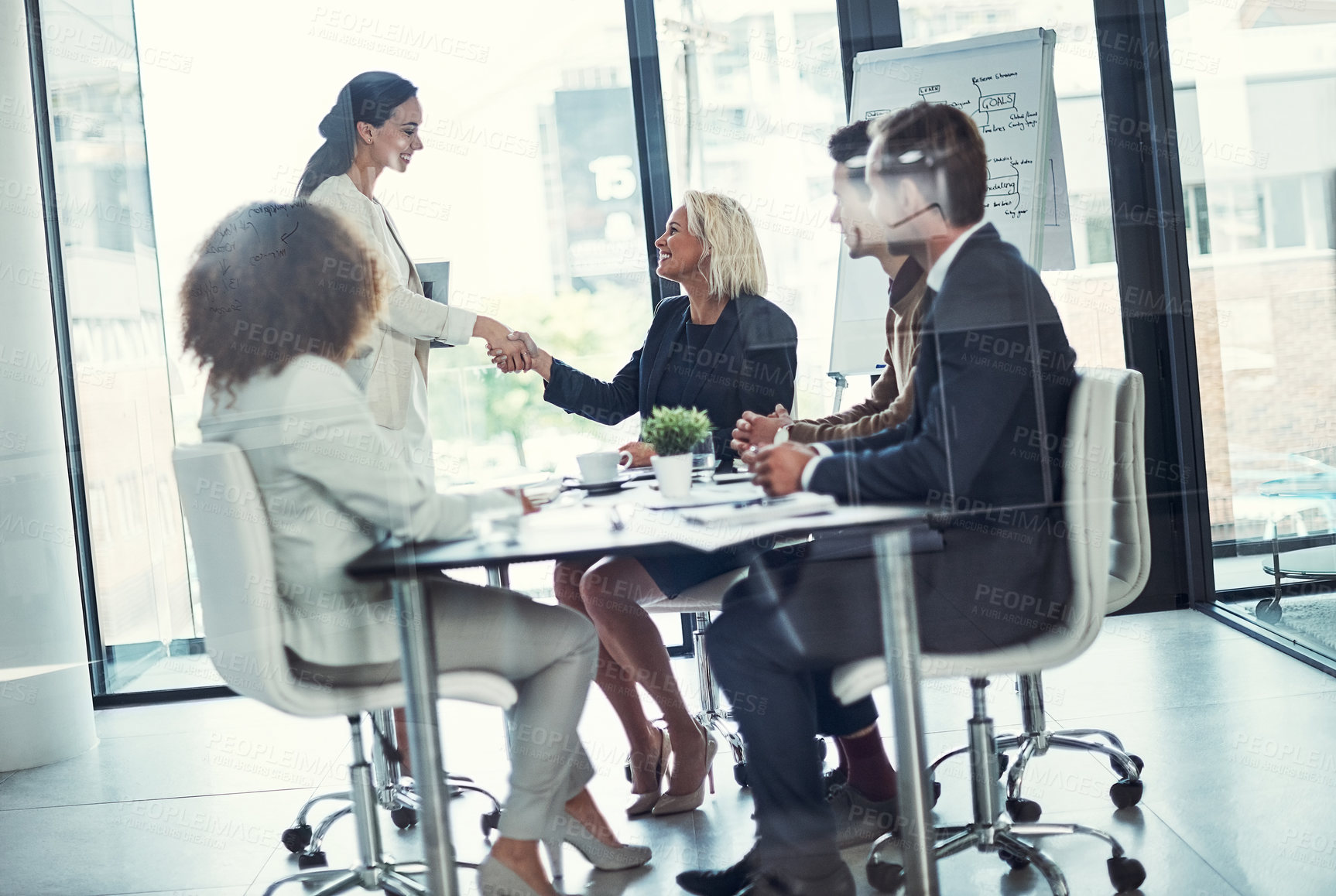 Buy stock photo Shot of businesspeople shaking hands during a meeting in an office