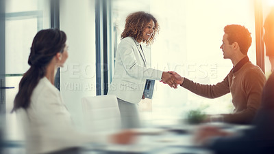 Buy stock photo Cropped shot of businesspeople shaking hands during a meeting in an office