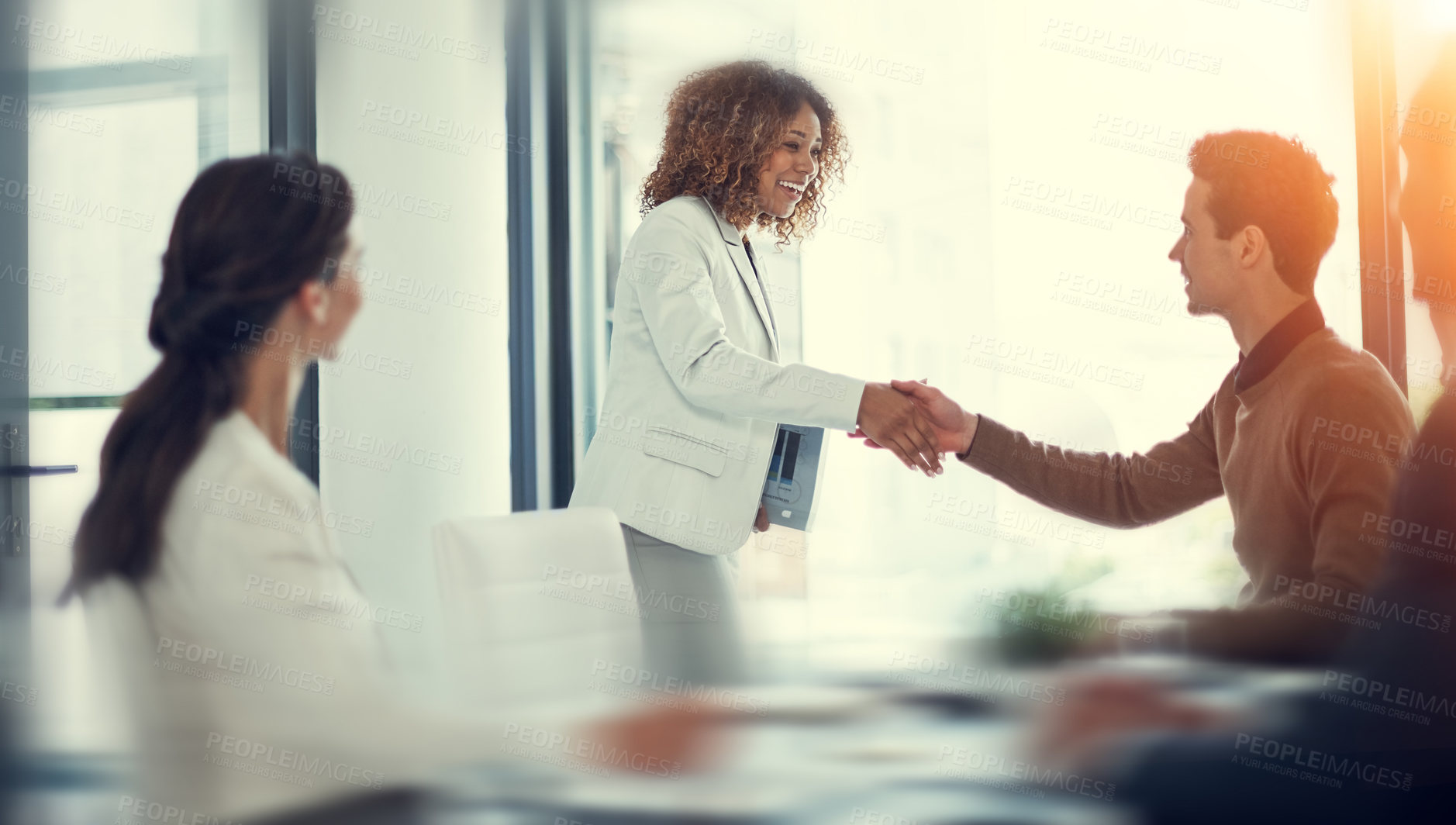 Buy stock photo Cropped shot of businesspeople shaking hands during a meeting in an office